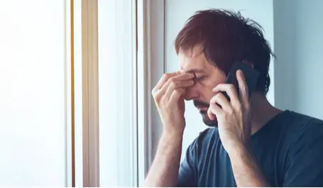 anxious man making  unpleasant phone call